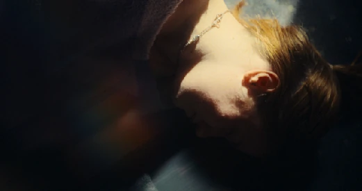 A quiet moment, a hand resting against a forehead.