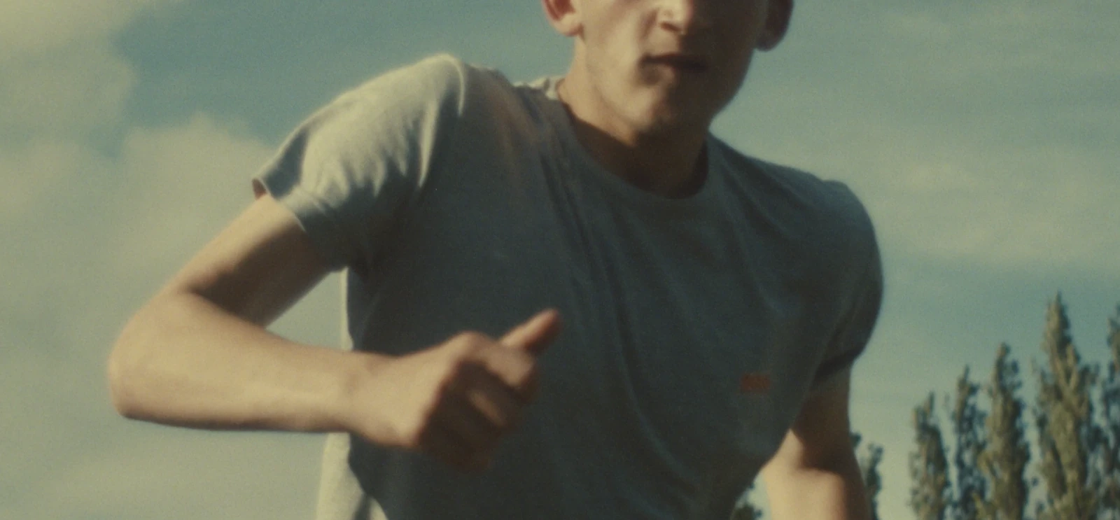 A young person running outdoors.