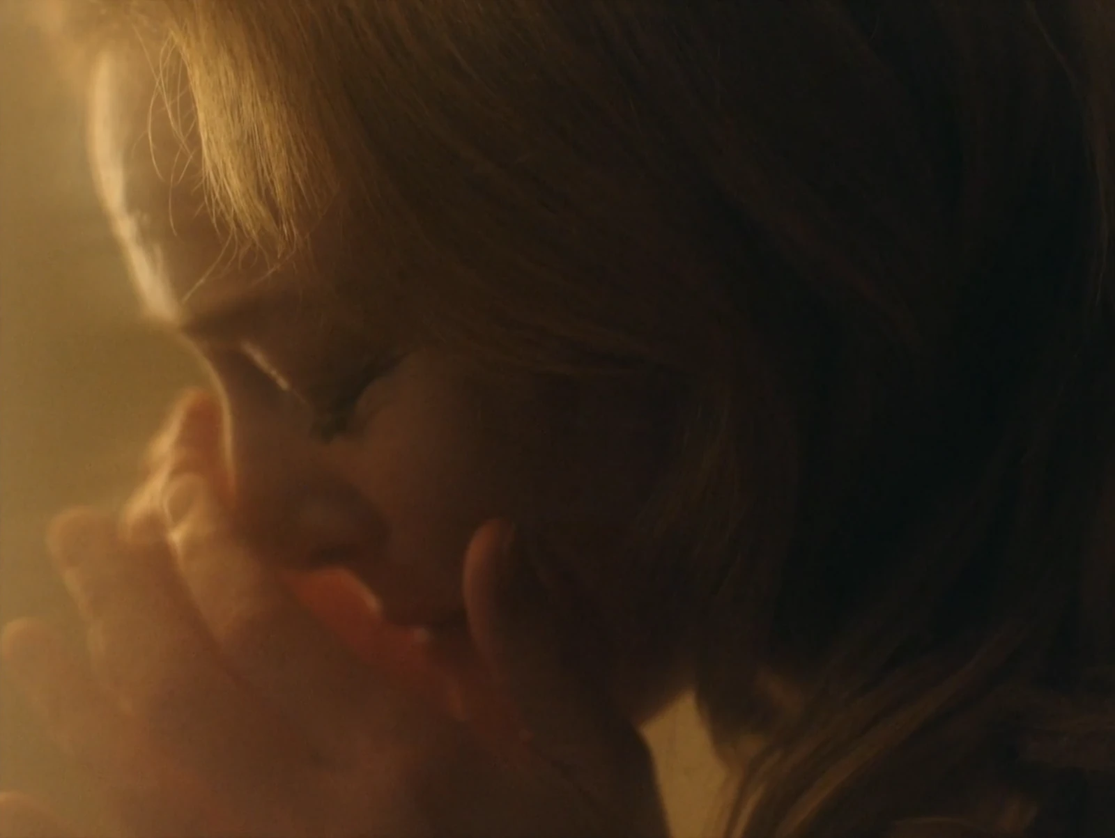An intimate close-up in warm light.