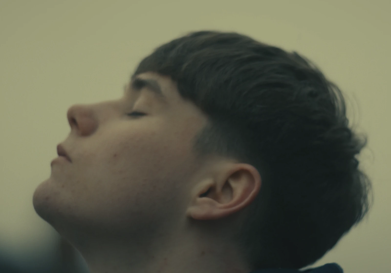 A close-up profile with eyes closed.